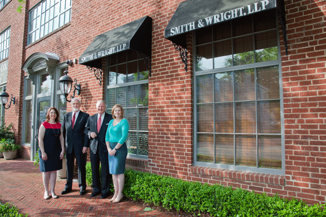 Staff of Smith & Wright outside office.